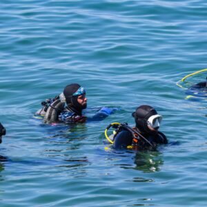 Group of scuba divers at the surface preparing to dive