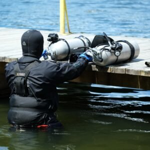 Scuba diver descending into deep blue water